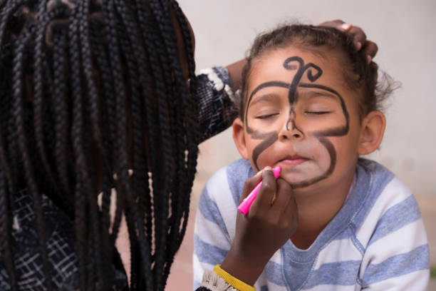 kids face painting. - face paint human face mask carnival imagens e fotografias de stock