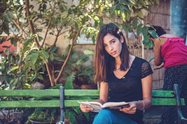 Cuban young woman studying in the garden