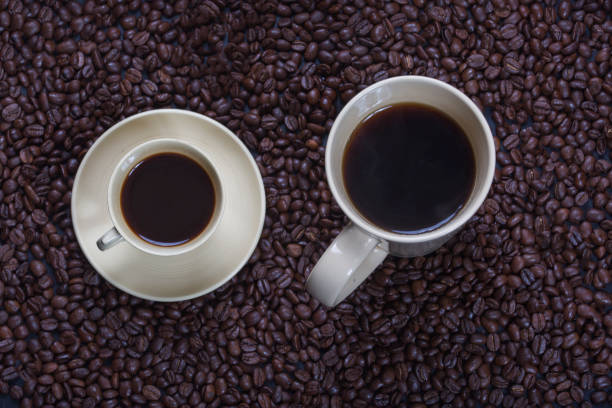 istock Close-up of coffee mug and cup on coffee beans 924809550
