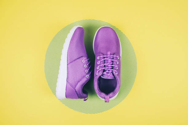 istock Lilac sneakers on a multi colored pastel surface 924813760