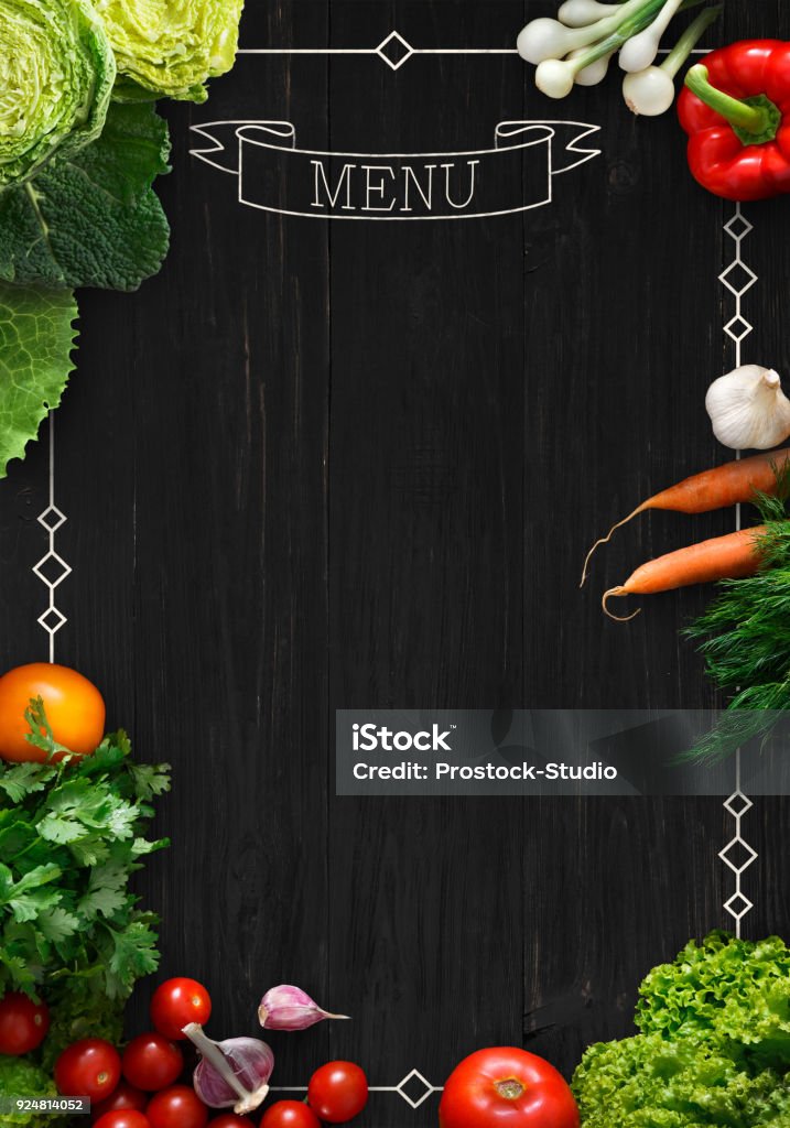 Black chalkboard as mockup for restaurant menu Design concept for restaurant menu mockup. Black rustic chalkboard with white inscription and vegetables frame, top view, copy space for text and logo, vegetarian cafe concept Chalkboard - Visual Aid Stock Photo