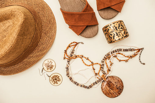 Still Life, Brown Sandals, Necklace, Straw Hat and Earrings Isolated on White