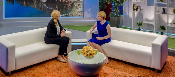 istock Female talk show host talking to her female guest in studio 924824734