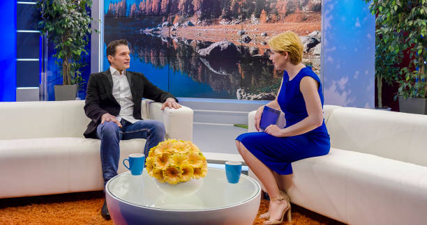 istock Female talk show host talking to her celebrity guest 924824764