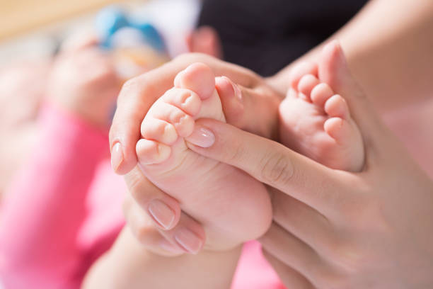 istock Mother take a Baby Exercise for Relief from Baby Constipation, Selective focus 924825202