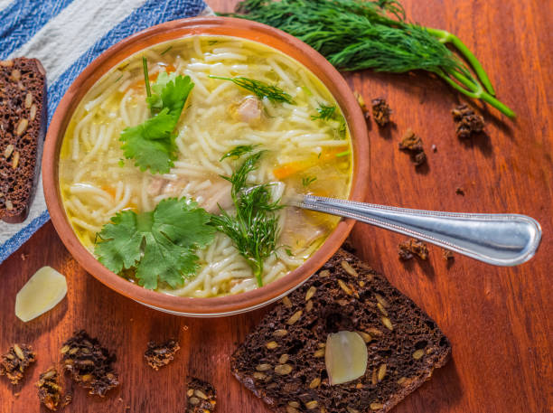 istock Homemade chicken soup with grain bread, garlic. 924825438
