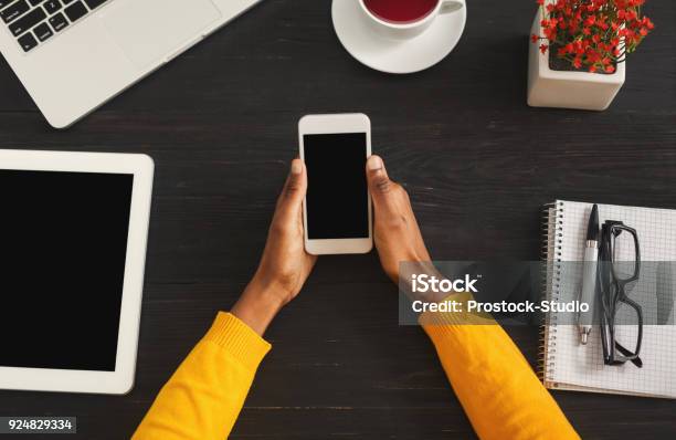 Black Female Hands Holding Smartphone Top View Stock Photo - Download Image Now - Dark, Flat Lay, Hand