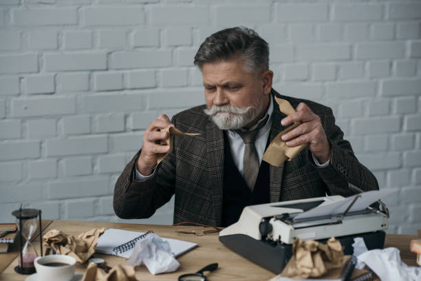 istock depressed senior writer tearning his manuscript 924829468
