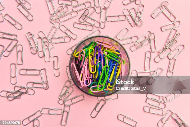 The Concept Of Order And Chaos Chaotic Scattered Silvery Paper Clips On Pink Background And Ordered Stacked Multicolored Paper Clips The Concept Of Organized Society Stock Photo - Download Image Now