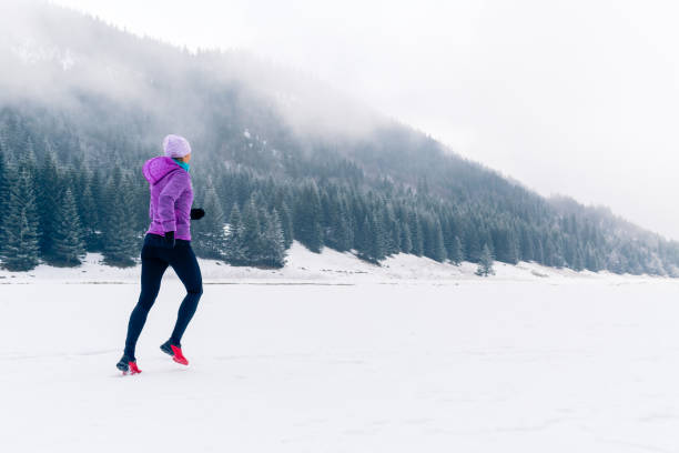 woman running on winter trail, fitness inspiration and motivation - journey footpath exercising effort imagens e fotografias de stock