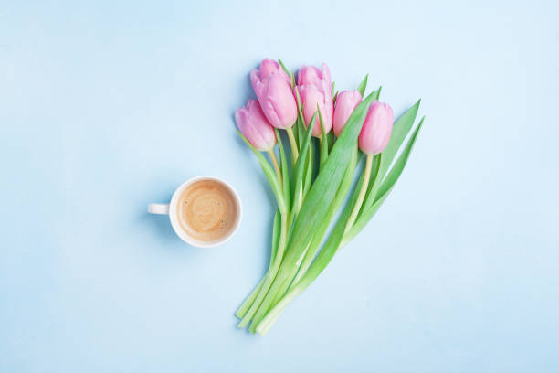 istock Fresh coffee and pink tulip flowers on pastel background top view. Beautiful spring breakfast on Mothers or Womans day. 924830180