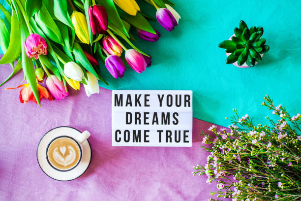 istock Make your dreams come true written in lightbox with spring flowers from above 924832300