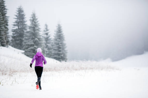 istock Trail running woman in winter mountains 924834020