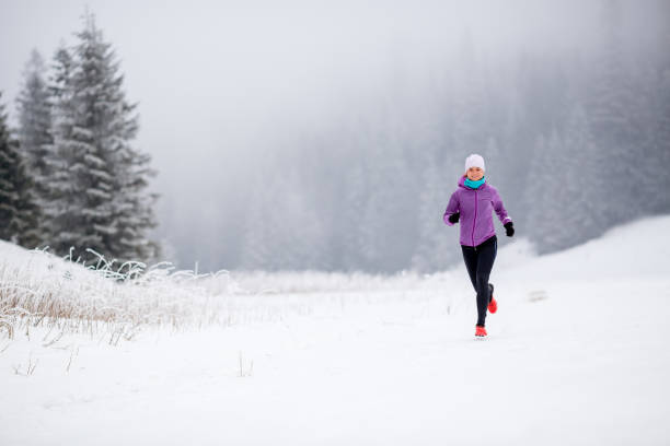 istock Trail running girl in winter mountains 924834218