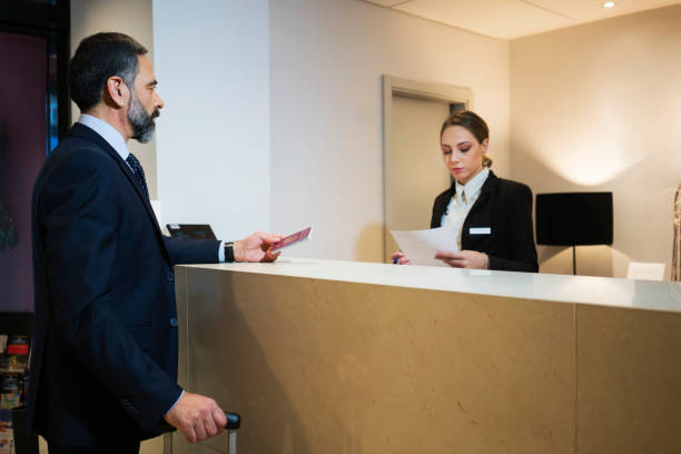 istock Business man at reception desk 924836992