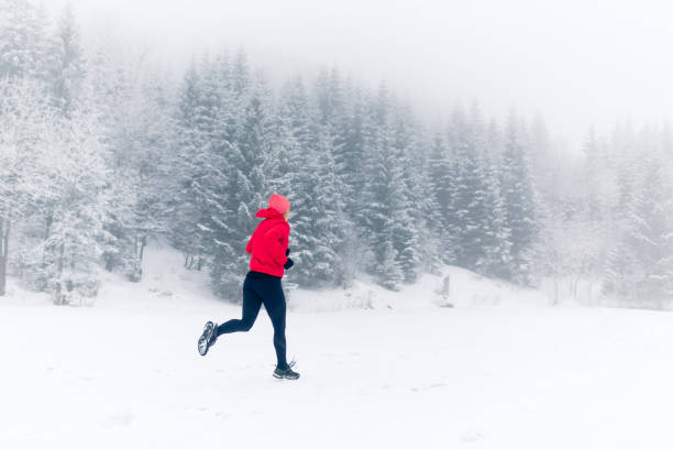 istock Woman running on snow in winter mountains 924837046