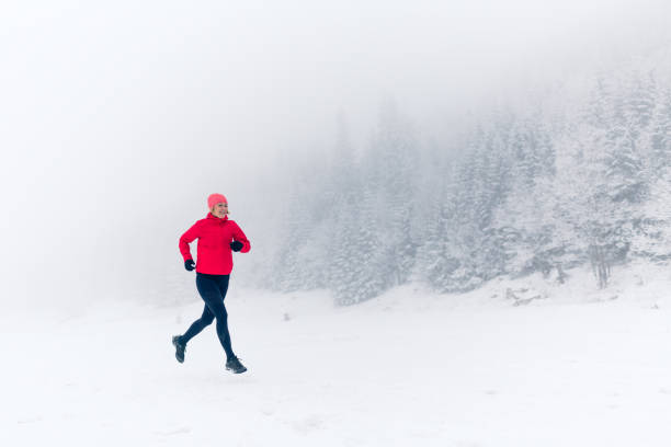 istock Woman running on snow in winter mountains 924837126