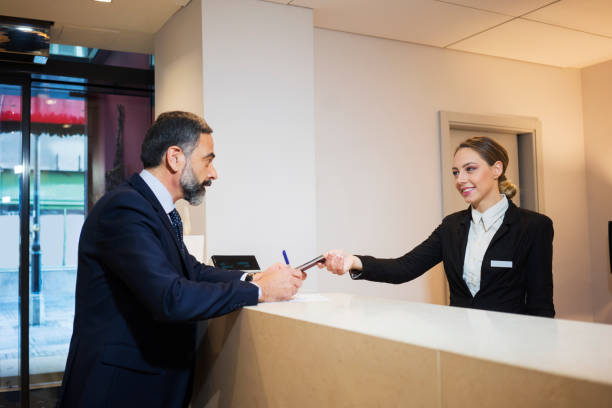 istock Business man at reception desk 924837488