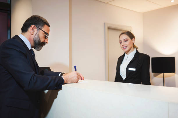 istock Business man at reception desk 924837860