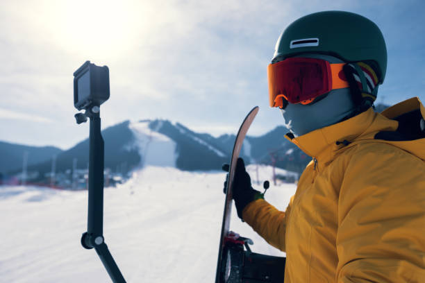 one snowboarder use action camera taking selfie on winter ski resort piste one snowboarder use action camera taking selfie on winter ski resort piste alpine climate photos stock pictures, royalty-free photos & images
