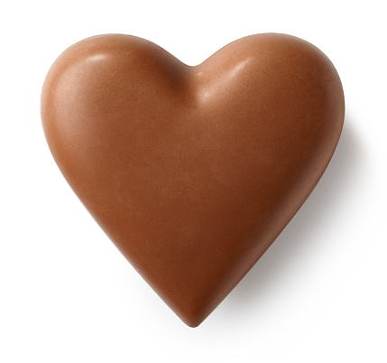 Milk chocolate heart isolated on white background. Top view