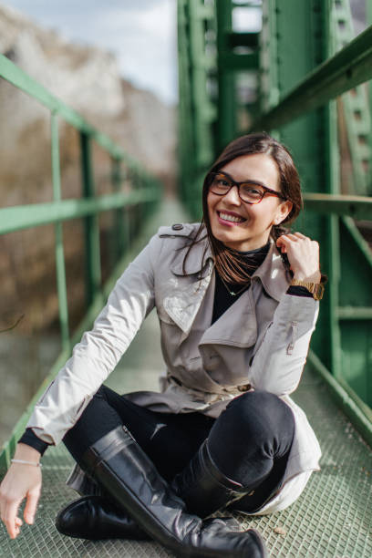 istock Young girl sitting on the green bridge 924849846