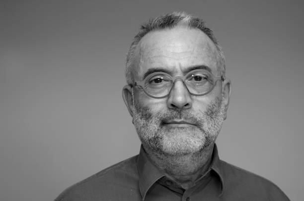 istock middle-aged man with blue shirt and glasses 924853470