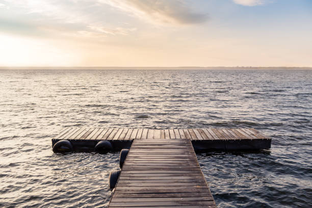 istock Peaceful empty wooden bridge in the morning sun 924853518