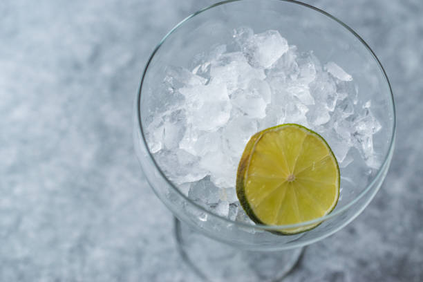 istock Crushed Ice in Cocktail Glass with Lime on Blue Surface. 924858814