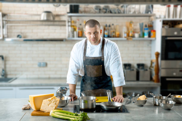 istock Handsome male chef in the kitchen interior 924860978