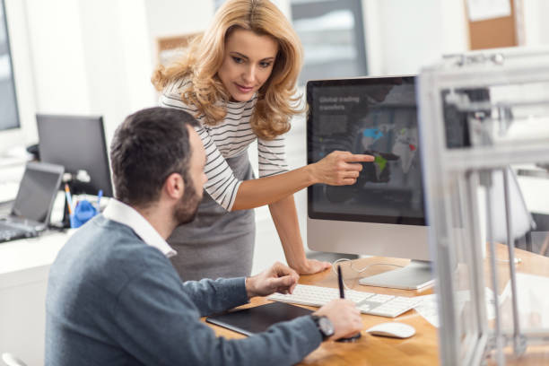 istock Pleasant female boss pointing at mistake in colleagues presentation 924861266