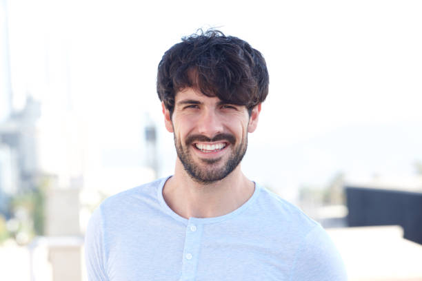 istock horizontal portrait of handsome young man smiling outside 924861440