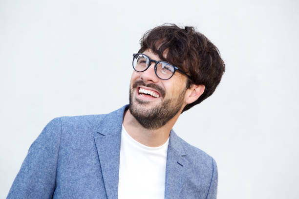 istock Close up happy man with glasses laughing against white background 924861492