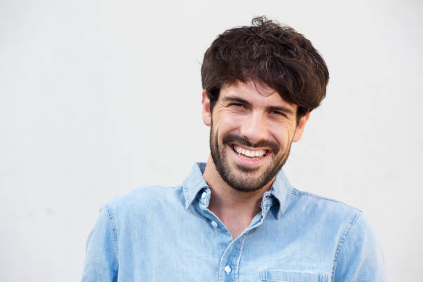 istock Close up smiling young man with beard against white background 924861592