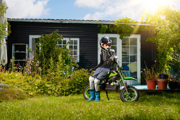 cute smiling boy is flying on his bike in spring season