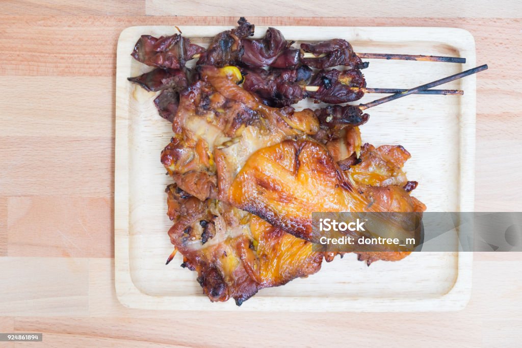 Thai style barbecue chicken meat and entrails on wood tray Animal Stock Photo
