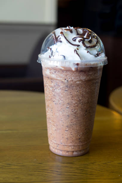 istock Coffee frappe covered with whipped cream in plastic glass 924862260
