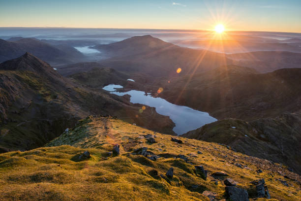 Snowdonia National Park Sunrise as viewed from the top of Snowdon in the Snowdonia National Park. mount snowdon photos stock pictures, royalty-free photos & images