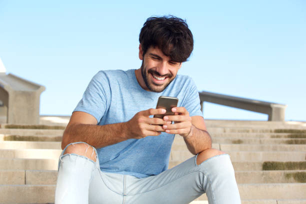 istock happy young man sitting with cellphone 924867002