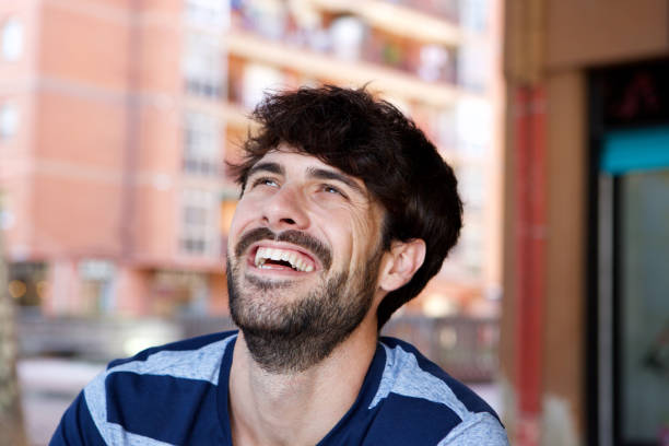 istock Close up handsome young man laughing outside 924867102
