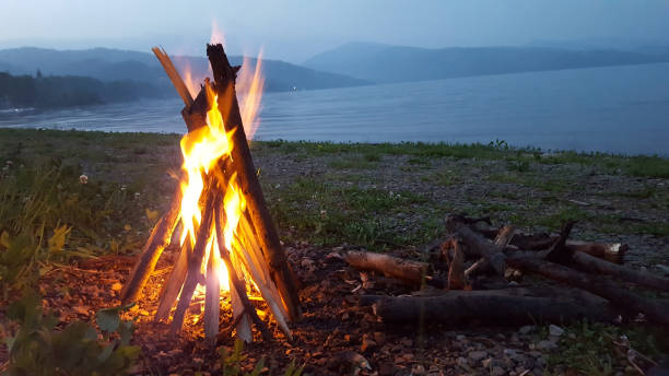 istock Campfire at night on the beach by the lake. 924872128