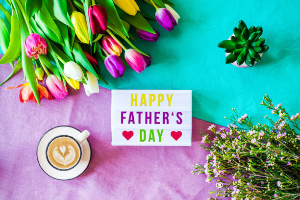 istock Happy father's day written in lightbox with spring flowers from above 924878020