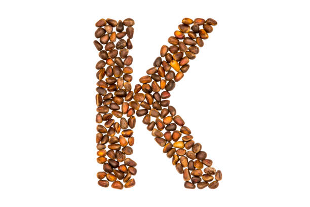 istock Alphabet made of nuts isolated on white 924890608