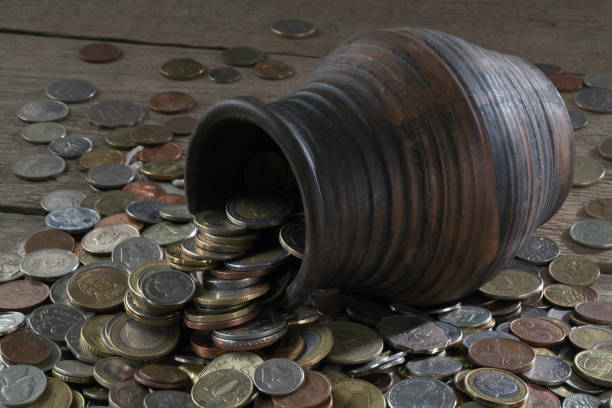 istock Clay pot and pile of coins 924893922