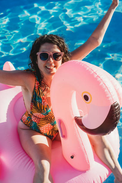 istock Woman with flamingo inflatable during vacation 924894026