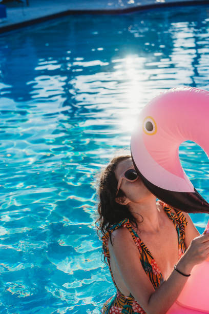 istock Woman with flamingo inflatable during vacation 924894056