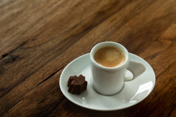 istock A cup of espresso with a chocolate candy maple leaf shaped on wooden background 924895596