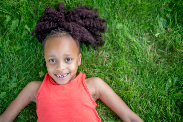 istock Happy Girl Laying In Grass 924899010