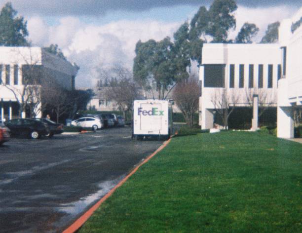 San Ramon, California, United States - January 25, 2018:  Federal Express (Fedex) truck making a delivery to a John Muir Health facility on a sunny day in San Ramon, California, January 25, 2018. True analog film photograph shot on 1970s era Teleinstamatic 608 camera