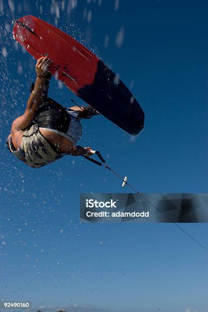 Wakeboarder Shot From Under Flies Through The Air Stock Photo - Download Image Now - Wakeboarding, 20-29 Years, 30-39 Years